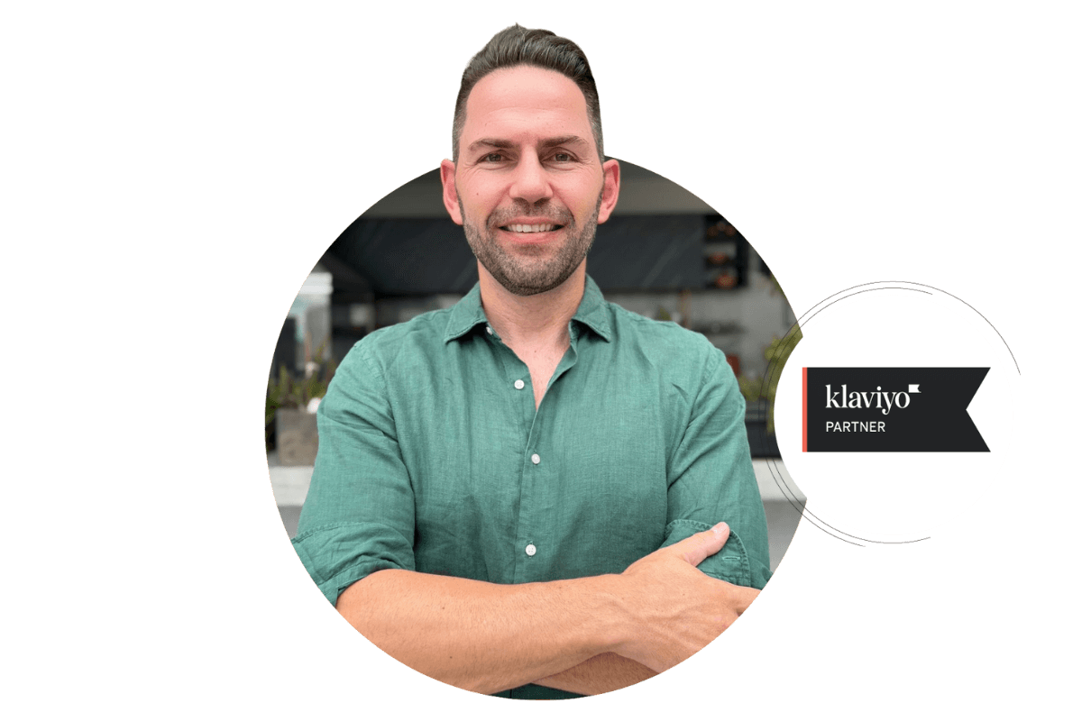 A man in a green shirt smiling with arms crossed, featured in a circular frame next to the Klaviyo Partner badge, indicating certified partnership with the email marketing platform.