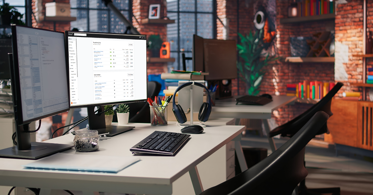 Modern office workspace with dual monitors displaying analytics dashboards, surrounded by tech accessories and colorful decor, representing a digital marketing and eshop support environment for performance tracking and optimization.
