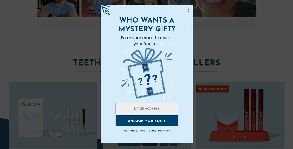 Email capture popup that reads, “Who wants a mystery gift? Enter your email to reveal your free gift.” Below is an email input field and a blue button labeled “Unlock Your Gift,” with a gift box illustration featuring question marks.