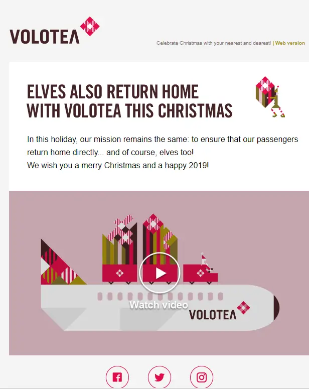 Holiday-themed email marketing newsletter design from Volotea featuring festive branding, a playful headline about elves returning home, and a message wishing subscribers a Merry Christmas and Happy 2019. The layout includes a stylized airplane graphic with presents and a play button encouraging viewers to watch a holiday video.